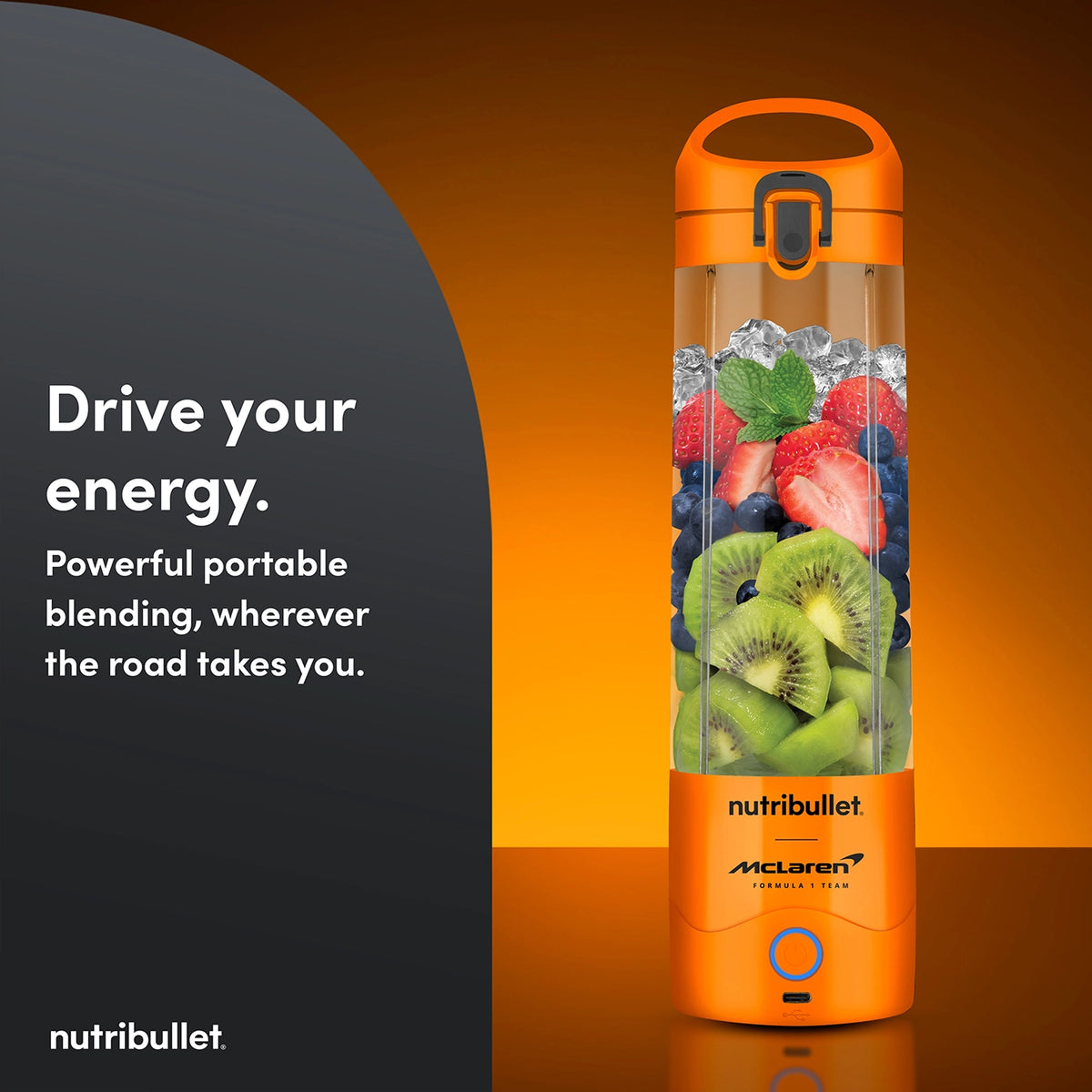 Nutribullet Portable McLaren blender in papaya orange filled with kiwi, blueberries, strawberries, and ice.