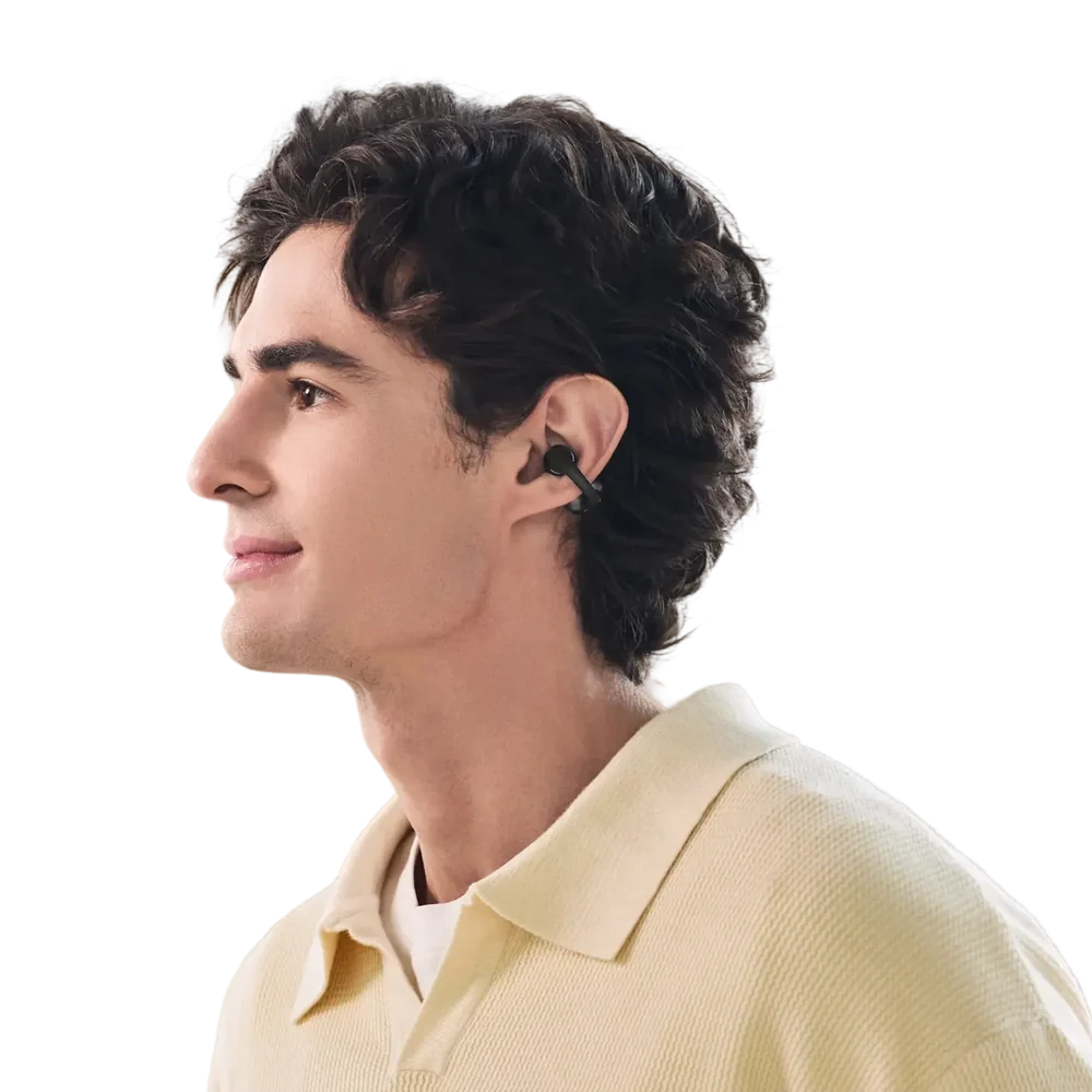 Man wearing Shokz OpenDots 2 Black bone conduction earbuds in his ears, side profile view