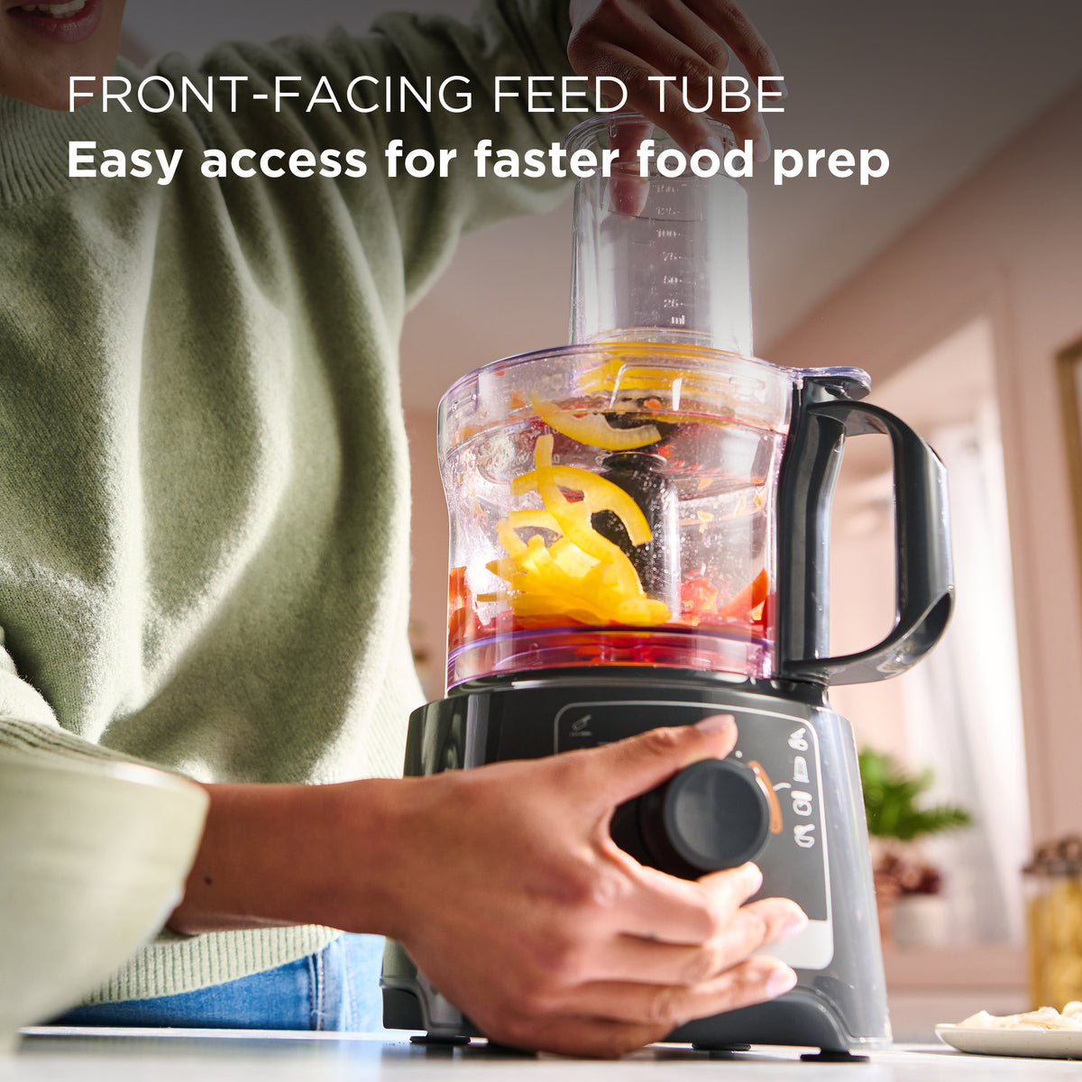 Kenwood MultiPro Compact food processor in use, blending sliced yellow peppers and other vegetables.