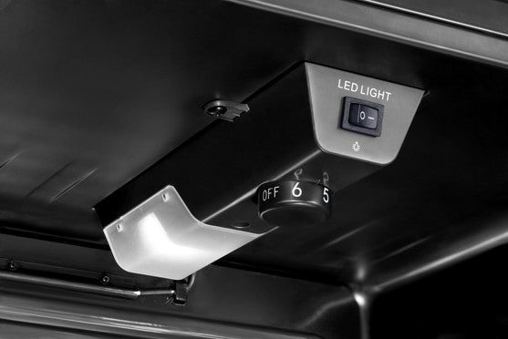 Close-up of the PowerPoint Beverage Cooler temperature control dial and LED light switch inside the unit.