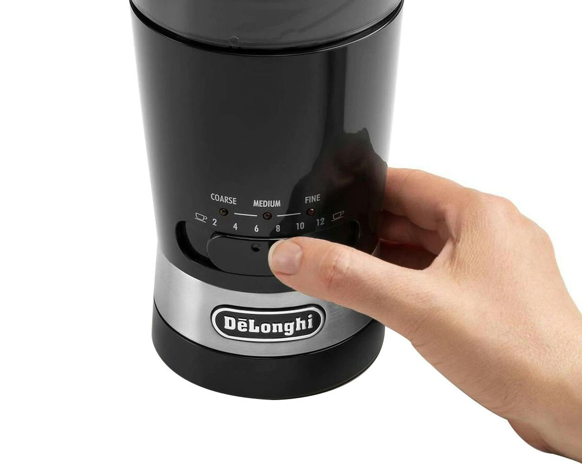 Hand adjusting grind size dial on black and silver Delonghi Electric Blade Coffee Grinder KG210