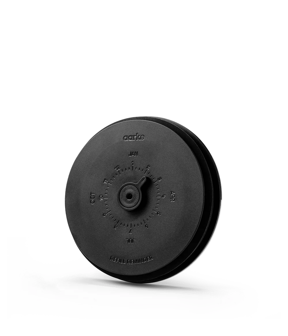 Black circular refill reminder dial for Aarke Purifier Large Glass Water Filter Pitcher, showing months and days.