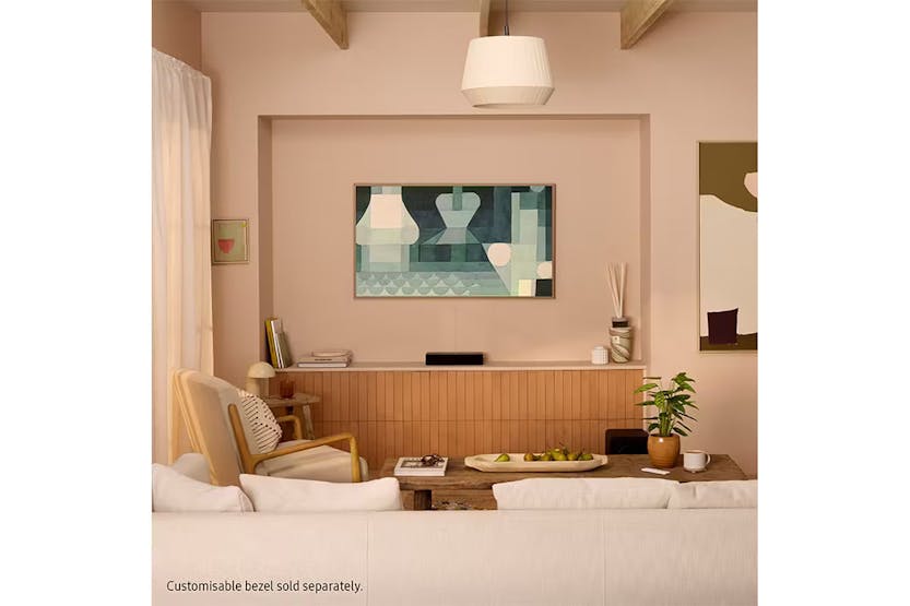 Samsung 65" LS03F QLED 4K Smart TV mounted on a living room wall with abstract art displayed