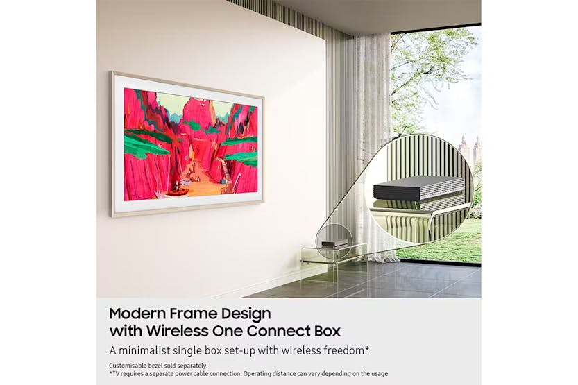 Samsung 65'' The Frame Pro Neo QLED 4K TV mounted on wall with colorful artwork and wireless One Connect Box on glass table
