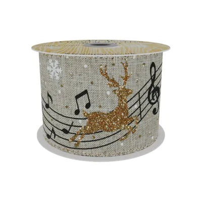 Natural ribbon spool with gold glitter reindeer and black musical notes on a beige fabric background.