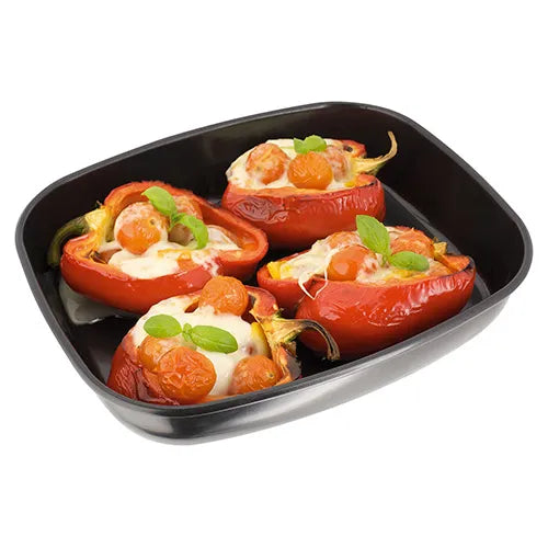 Stellar Bakeware non-stick roasting tray with stuffed red peppers and cherry tomatoes, angled view