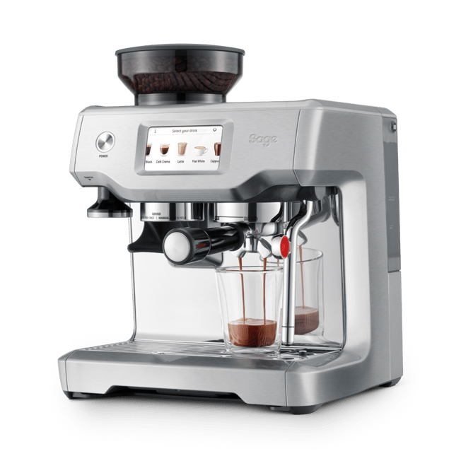 A silver Breville espresso machine with a digital touch screen, shown with a bean hopper on top and two glass cups receiving espresso on a clean white background.
