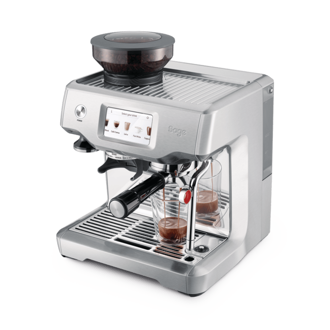 A silver Sage espresso machine with a dark bean hopper on top, shown with two glass cups of espresso on the drip tray against a white background.