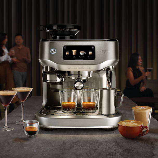 Sage Oracle Dual Boiler espresso machine brewing two shots with milk frother and various coffee drinks around it