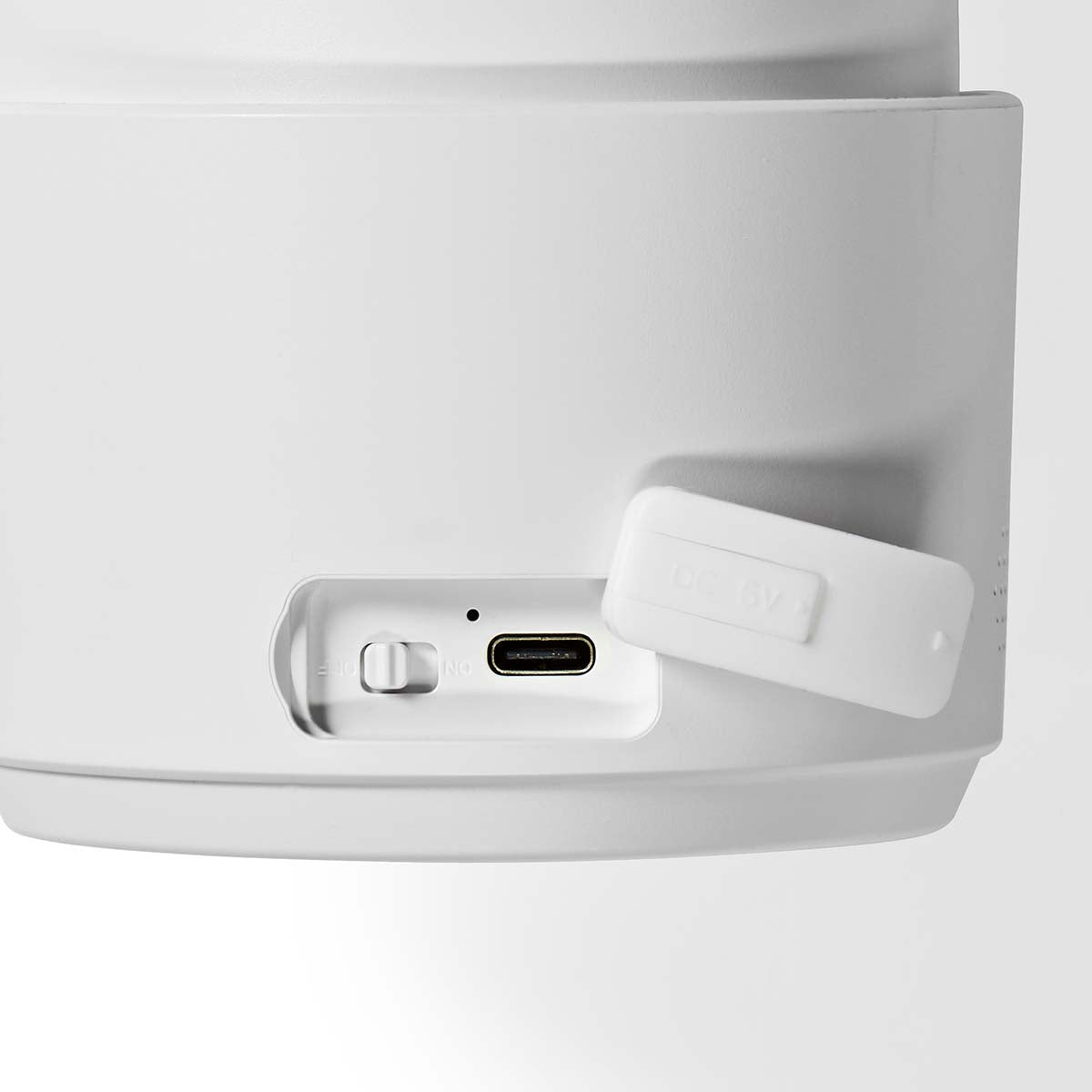 Close-up of the Nedis SmartLife Outdoor Camera 4G showing the power switch and USB-C charging port with cover open.