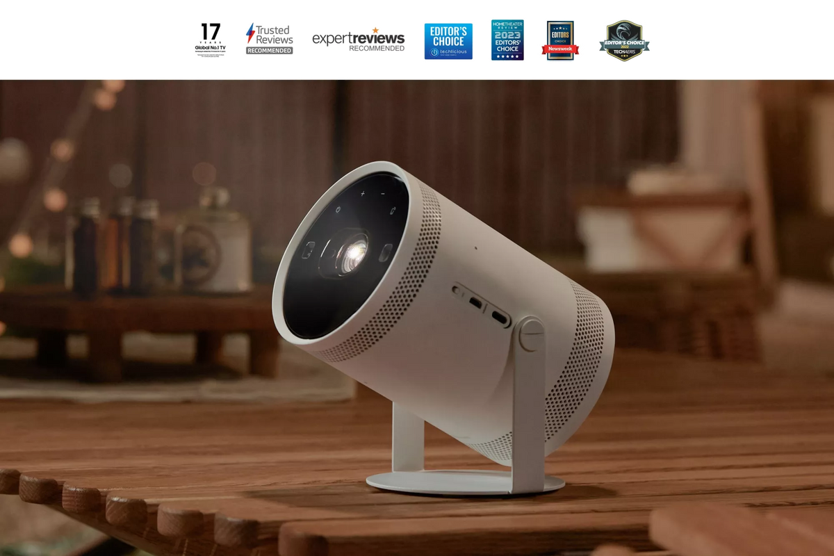 Samsung The Freestyle 2nd Gen Full HD Smart Projector TV angled on a wooden table in a cozy room setting