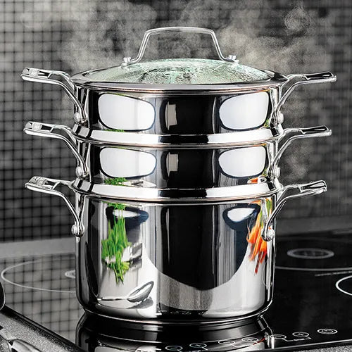 Stainless steel Stellar 22cm 3 tier steamer set with glass lid on a stovetop, steam rising