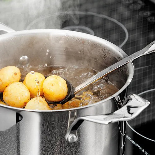 Stainless steel 22cm 3 tier steamer set with steam rising, showing potatoes being cooked in the bottom pot