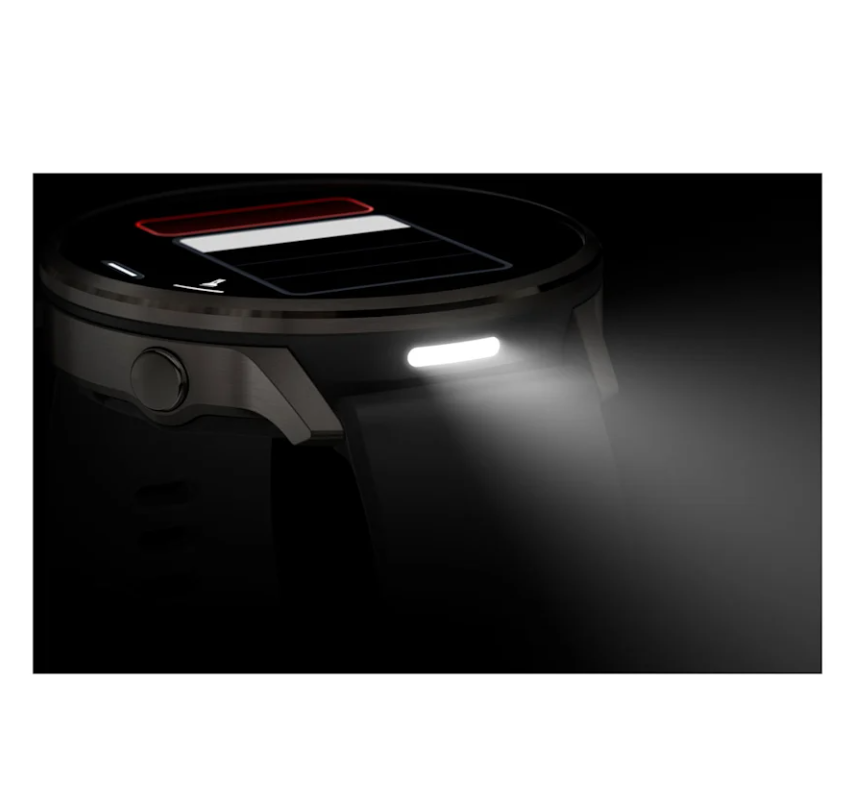 Garmin Venu 4 smartwatch in black with slate, showing built-in front light turned on in dark.