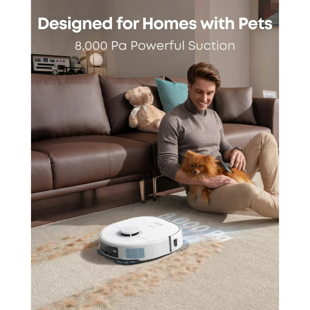 Eufy X10 Pro Omni robot vacuum cleaning pet hair on carpet near man sitting with small dog