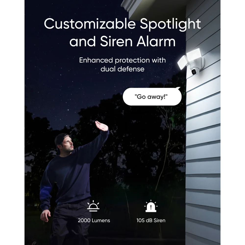Eufy Floodlight Camera E30 mounted on a house exterior with bright spotlights on at night.