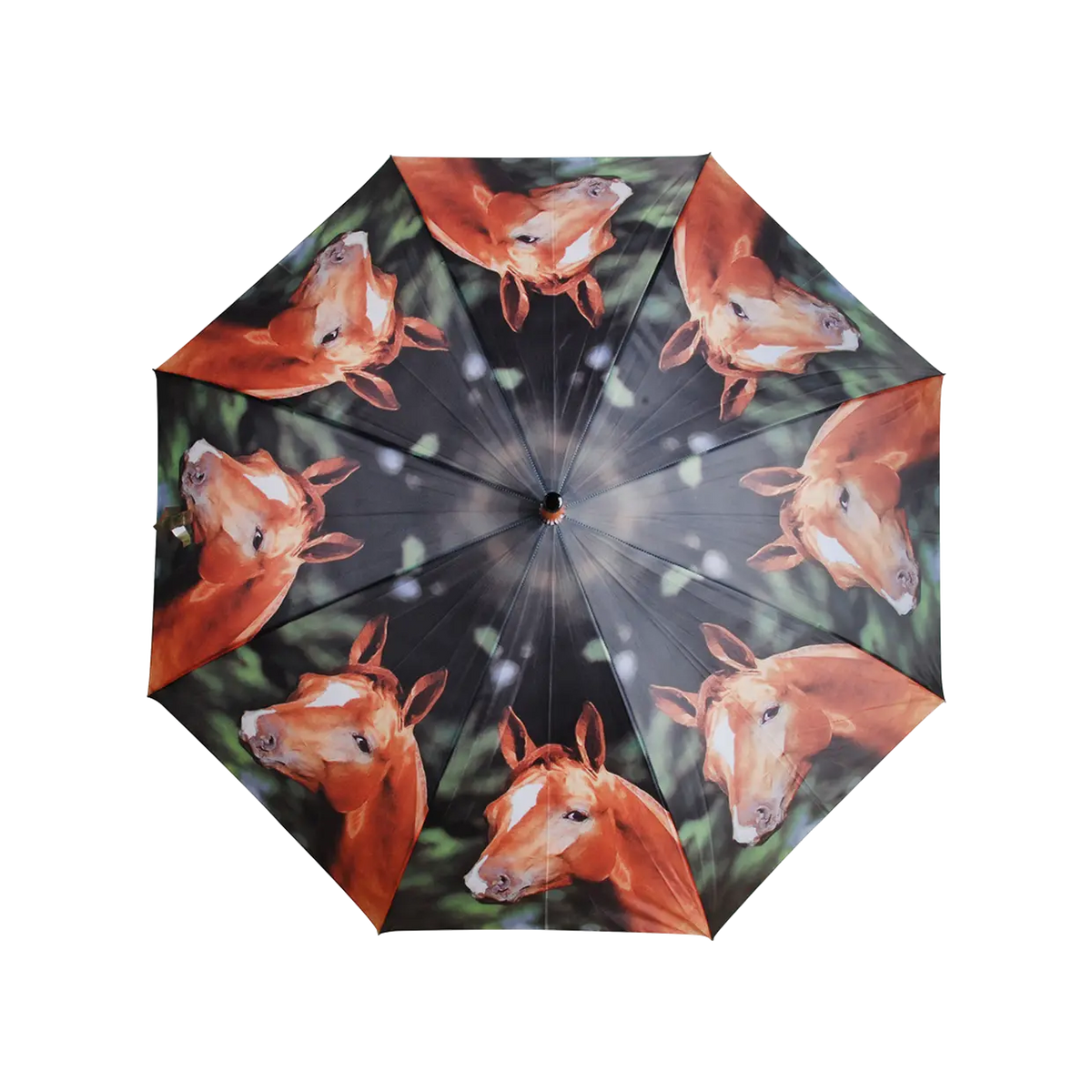 Open umbrella with a repeating horse head pattern on a dark, blurred background.