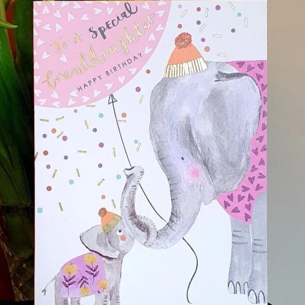 Birthday card with embossed gold foil text, featuring two elephants wearing hats and colorful confetti.