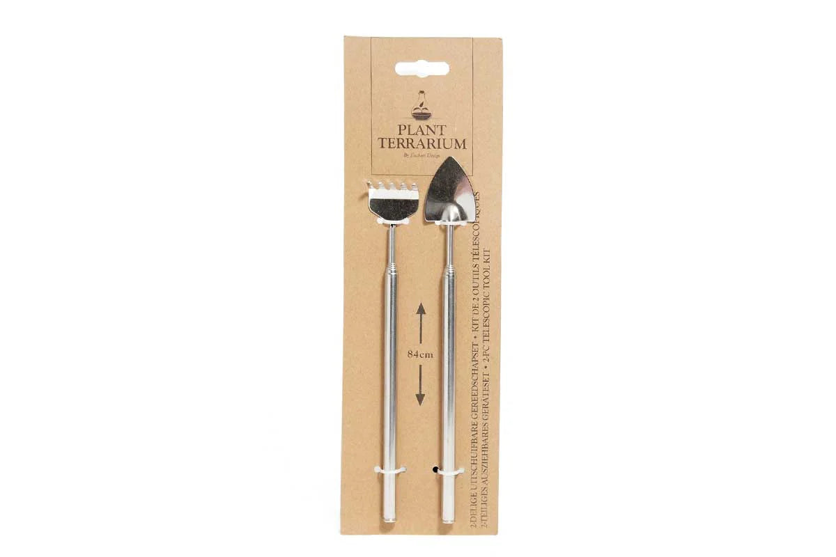 Terrarium mini tool set with metal rake and trowel on cardboard backing, telescopic handles shown extended.