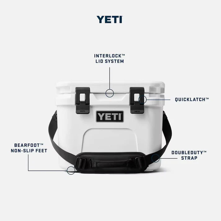 White YETI Roadie 15 cooler with black latches, strap, and labeled features on a white background.