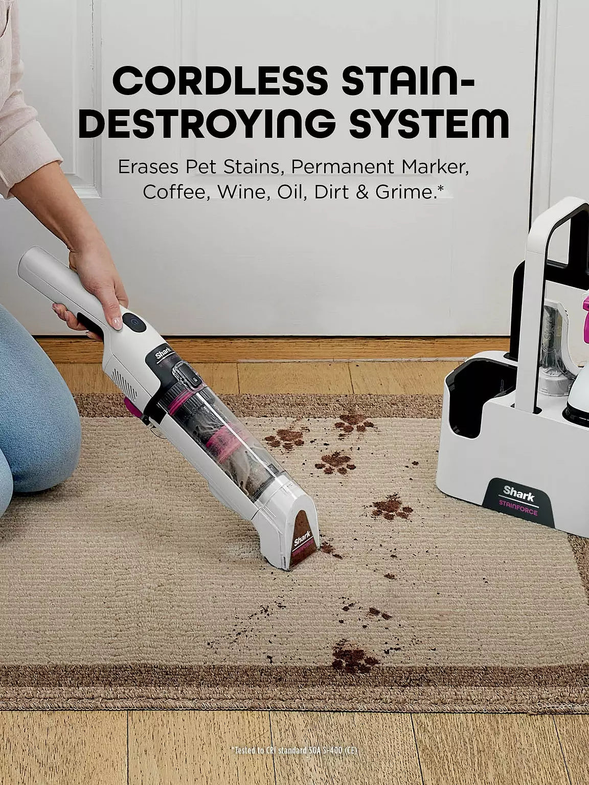 Handheld Shark Stainforce cordless spot cleaner removing dirt stains from a beige carpet.