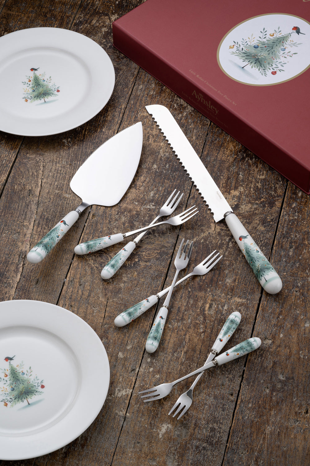 Aynsley Little Robin Christmas Tree Pastry Set with decorated plates, cake knife, server, and forks on wood table.