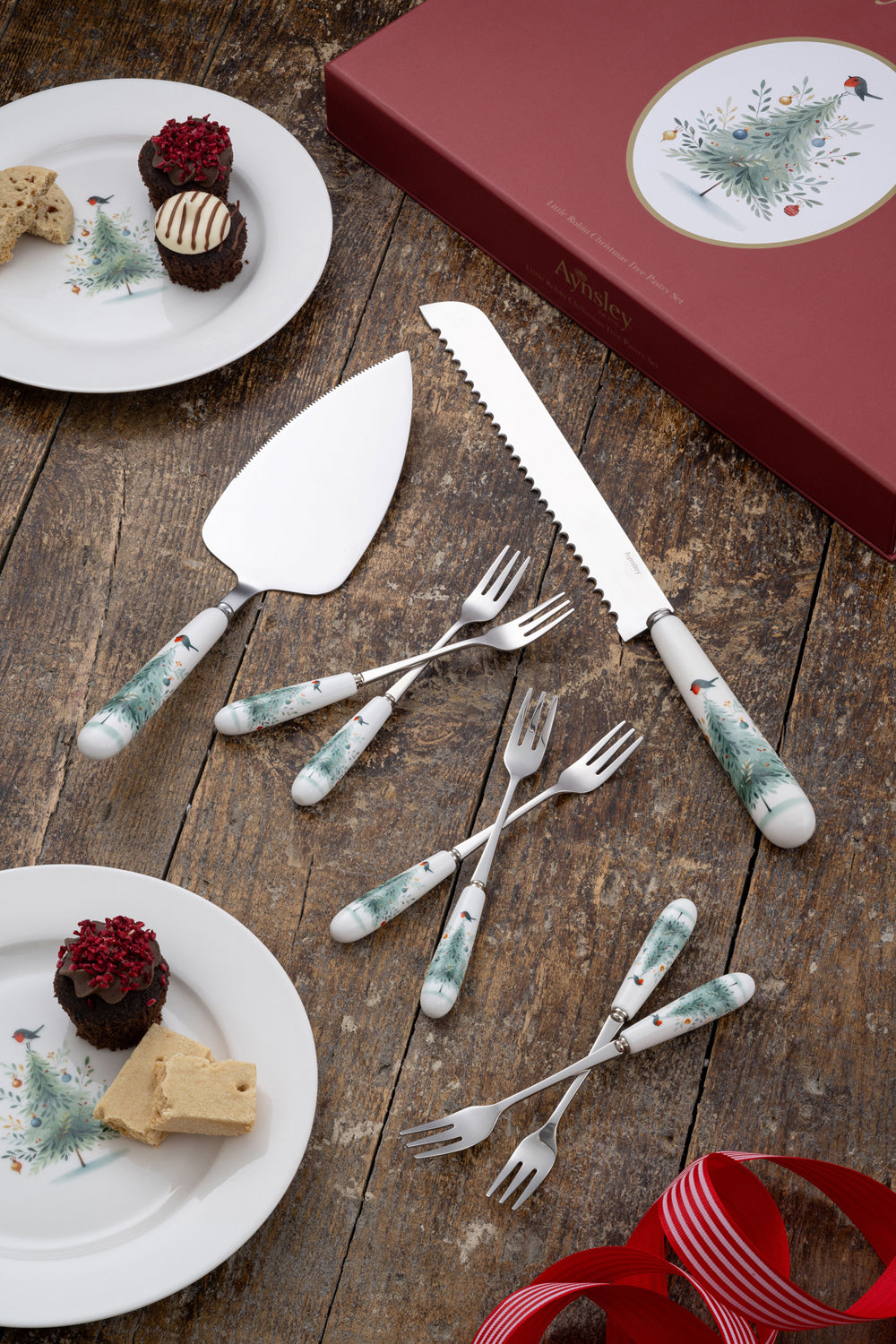 Aynsley Little Robin Christmas Tree Pastry Set with decorated handles, cake knife, server, and forks on wood table.