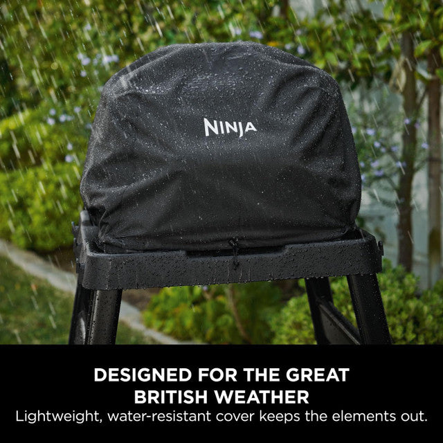 Black Ninja Woodfire XL Grill Cover on a grill in rain, showing water-resistant fabric with logo.