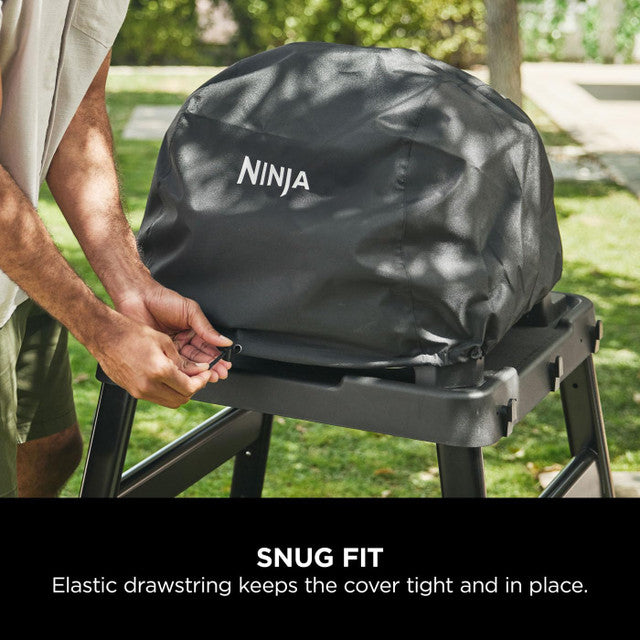 Black Ninja Woodfire XL Grill Cover secured with elastic drawstring on a grill outdoors