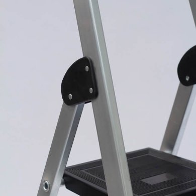 Close-up of Probuild 6 Thread Aluminium Trade Step Ladder showing black plastic hinge and textured step platform.