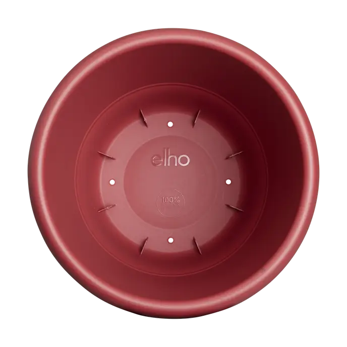 Top view of a 25cm round theatre red Amiga planter pot with drainage slots and embossed logo inside.
