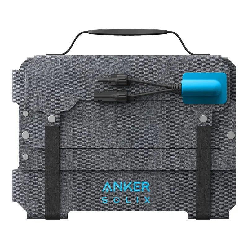 Folded Anker Solix PS100X portable solar panel with handle, connectors, and blue logo on gray fabric surface.