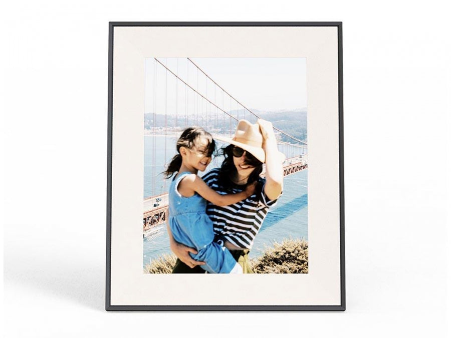 Aura Aspen 12" digital photo frame in ink with a photo of a woman and child by a bridge displayed on screen