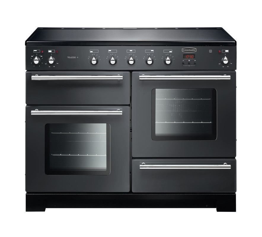 Rangemaster Toledo + 110 induction range cooker in black with double ovens and control knobs on top panel.