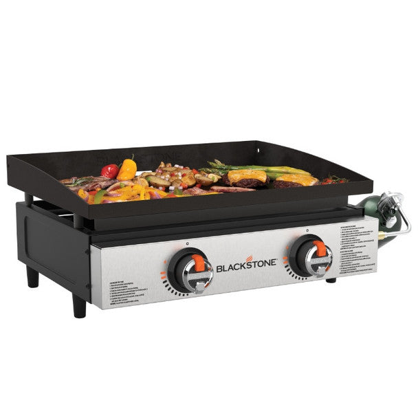 Blackstone 22" Tabletop Griddle with dual burners cooking vegetables and meats on a flat steel surface