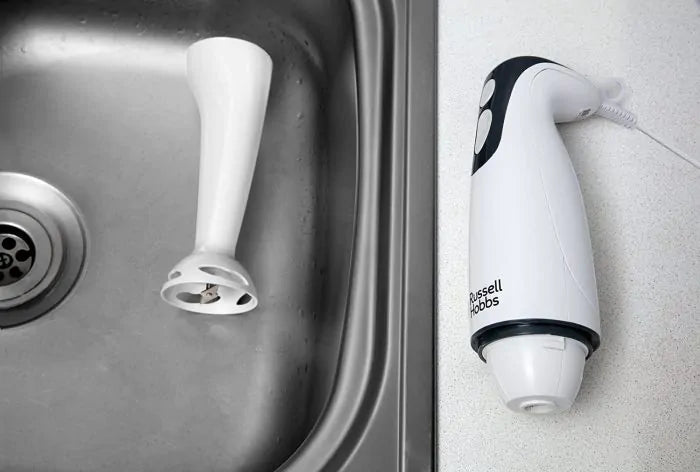 Russell Hobbs 200w hand blender with detachable blending arm placed beside a kitchen sink on a countertop.