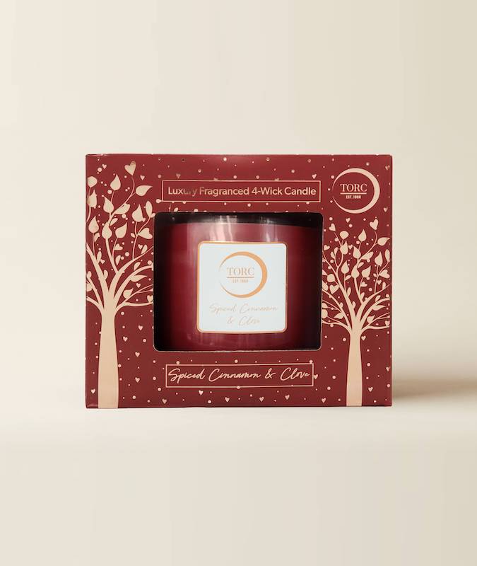 Torc Cinnamon Spice 4 Wick luxury candle in red glass with decorative red and cream box featuring tree designs.