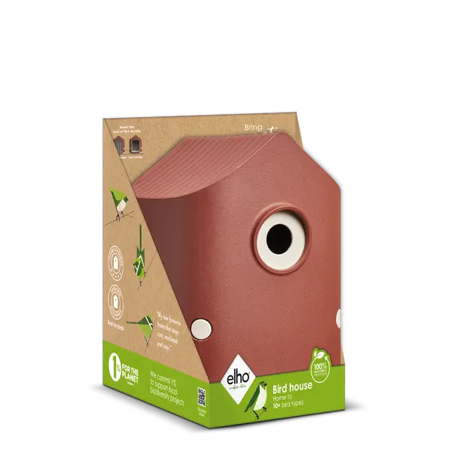 Cosy Bird House in Tuscan Red with a round entrance hole, shown in its eco-friendly packaging box.