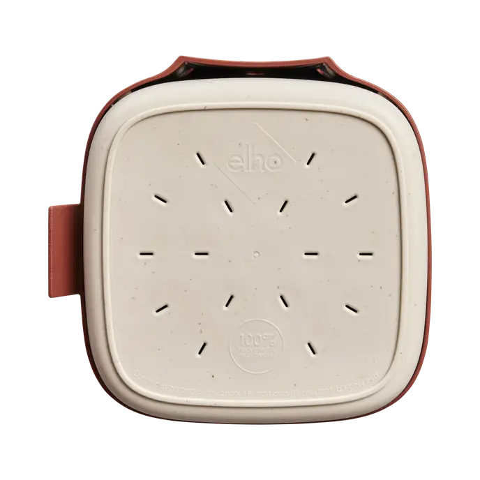 Top view of the Cosy Bird House 18cm in Tuscan Red showing drainage holes and beige base plate.