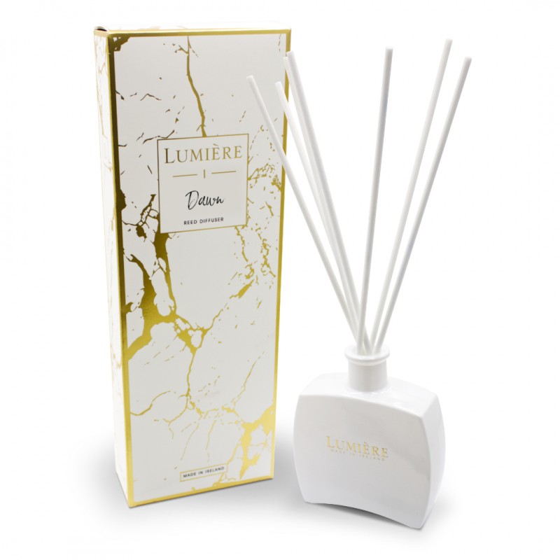 Lumiere Dawn 250ml diffuser with white ceramic bottle, gold logo, and six white reed sticks next to gold-accented box