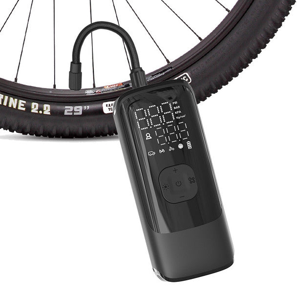Energizer Portable Air Compressor attached to a bicycle tire, showing digital display and controls.