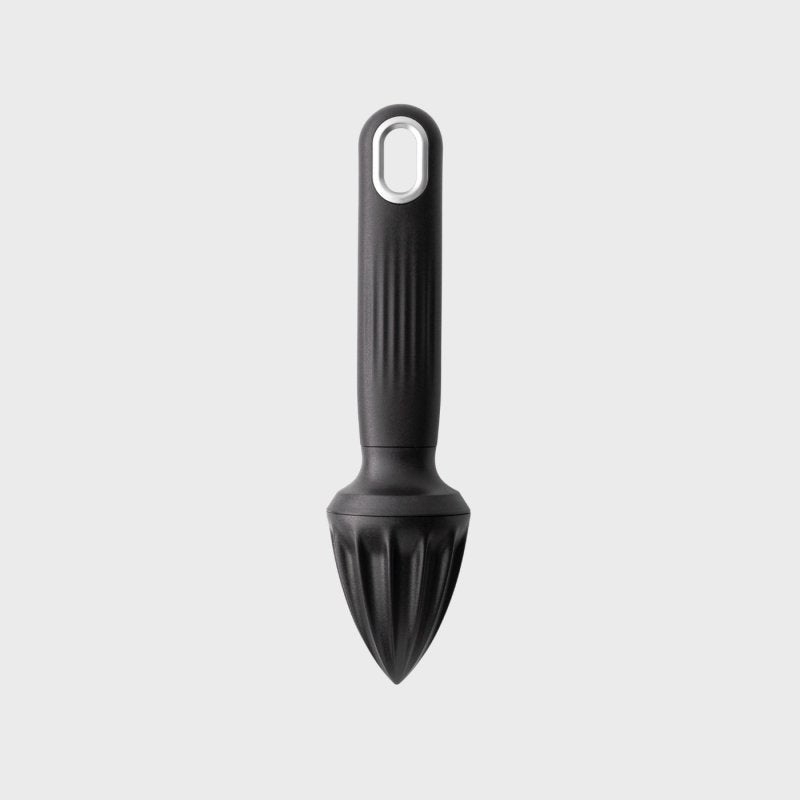 Black citrus reamer with textured handle and pointed ridged juicing head on a light background