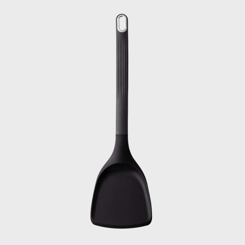 Black silicone solid wide turner with a long textured handle and hanging loop at the end.
