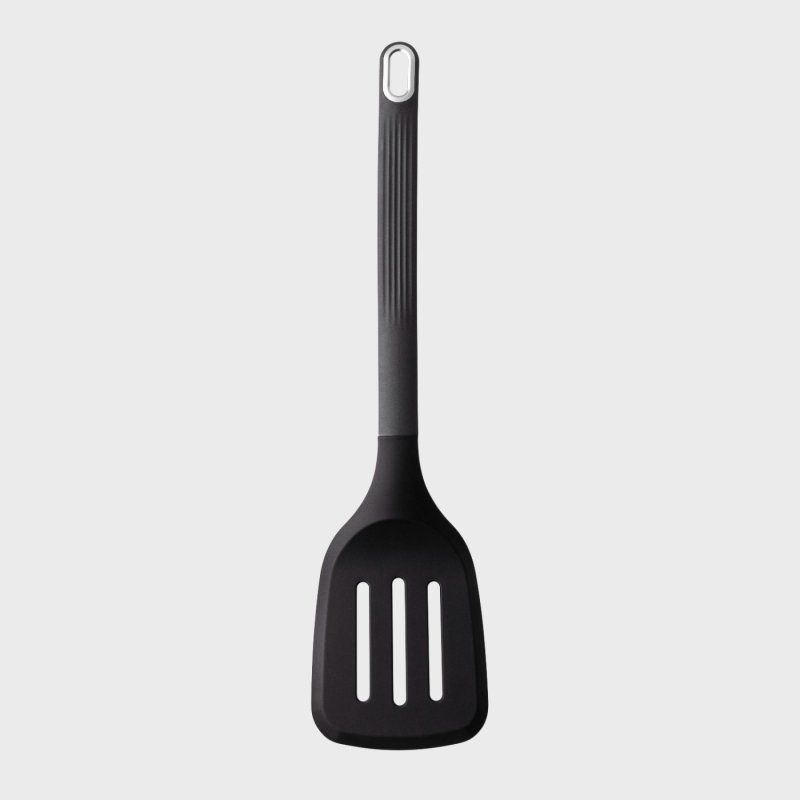 Black silicone slotted turner with a long handle and hanging hole at the top, shown flat on a gray background.