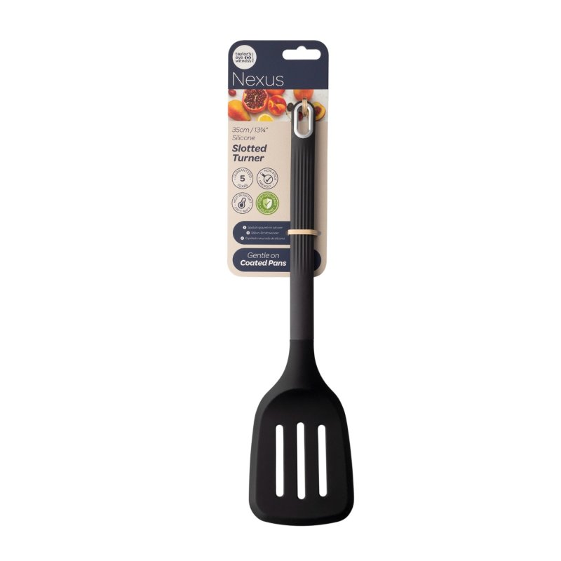 Black silicone slotted turner with a ribbed handle and hanging hole, attached to branded packaging.