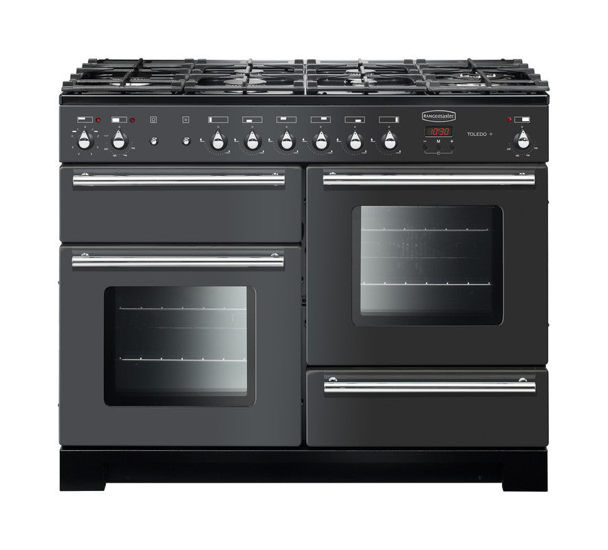 Rangemaster Toledo + 110 dual fuel range cooker in black with six burners and three ovens visible from the front.