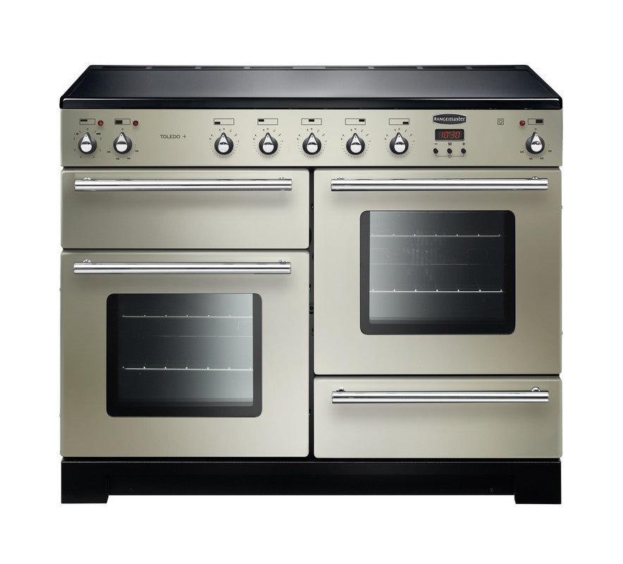 Rangemaster Toledo + 110 induction range cooker in cream with six control knobs and two ovens with glass doors