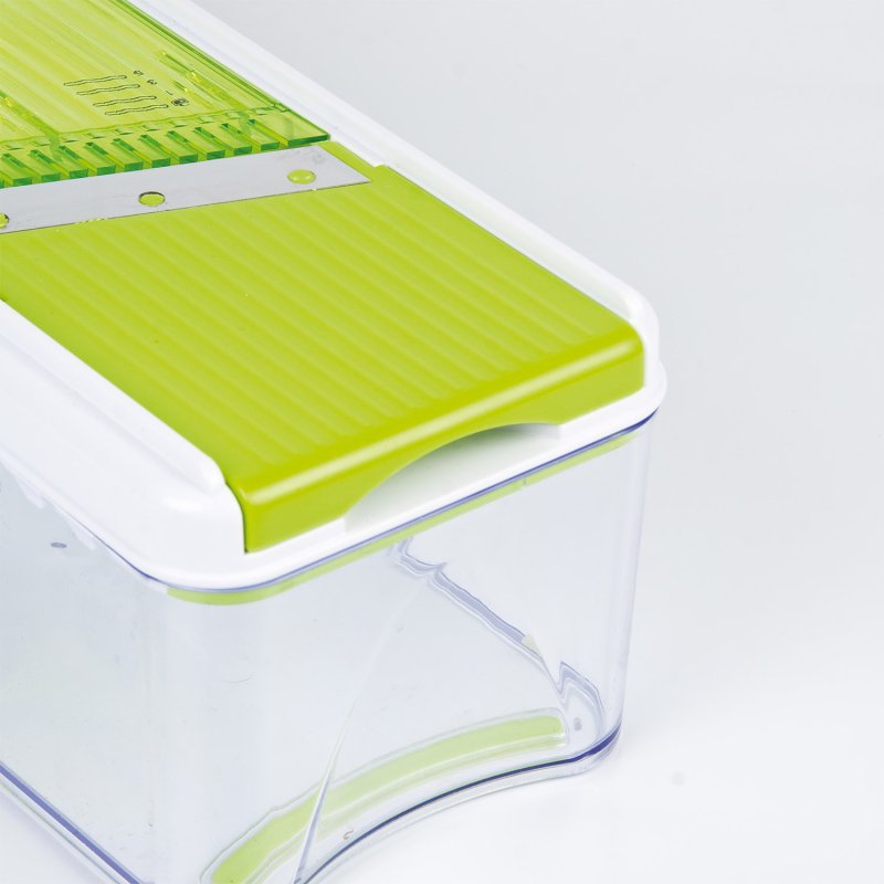 Clean Eating Multi Mandoline with green slicing surface and clear container base on white background