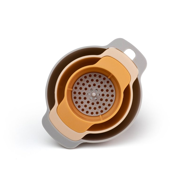 Top view of 3 piece nesting funnel set in muted gray, beige, and mustard colors with strainer insert.