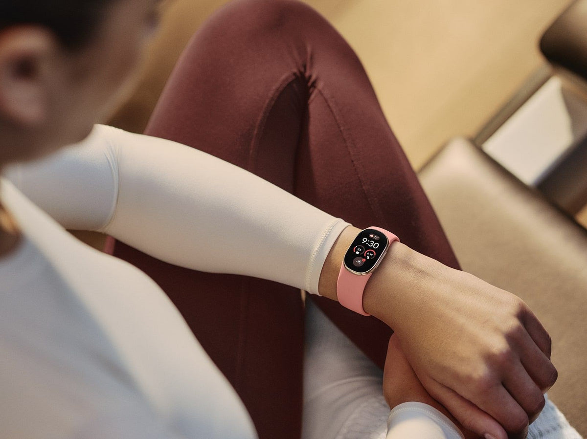 On Wrist view of Google Fitbit Edge Canyon Gold fitness tracker showing the heart rate sensor and Canyon Active Band